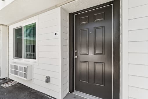 A black door with a number 43 on the wall.