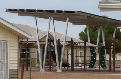 a playground with a swing set and climbing equipment