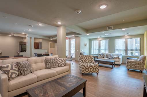 A living room with a couch, chairs, and a coffee table.