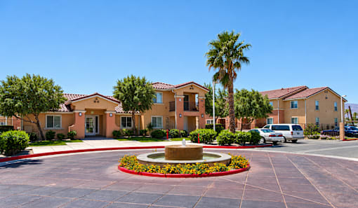 A building with a fountain in front of it.