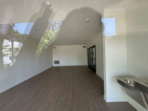 a view of the community room white walls and wood flooring