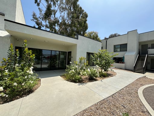the exterior of the community room with a courtyard in front of it