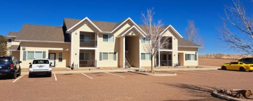 a large apartment complex with a parking lot