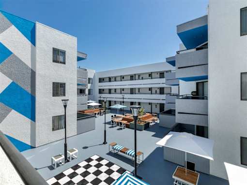 a view of the courtyard of a building with tables and umbrellas at Harbor Terrace Apartments, San Pedro , CA 90731
