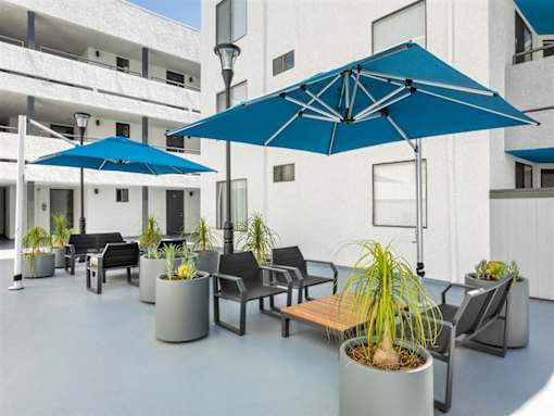 patio and umbrellas at Harbor Terrace Apartments, San Pedro