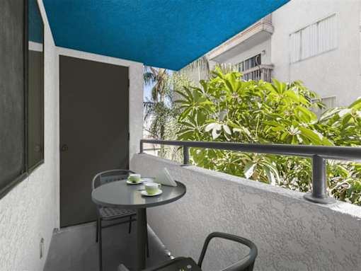 a balcony or terrace with a table and chairs at Harbor Terrace Apartments, San Pedro , CA