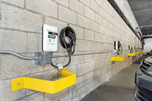 an electric car charging station on the wall of a parking garage at Harbor Terrace Apartments, San Pedro