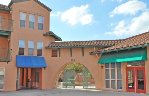 a building with a blue awning and an archway in front of it