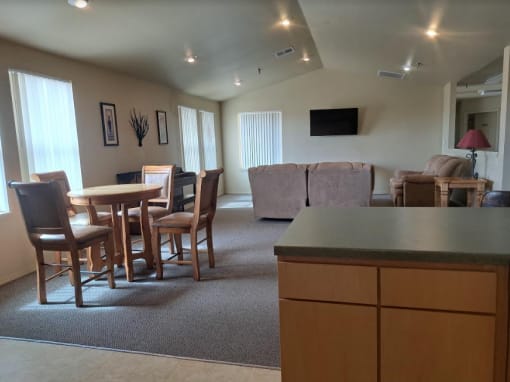a living room with a couch and a table with chairs