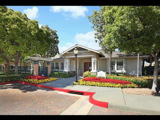 A house with a red brick pathway leading to the front door.