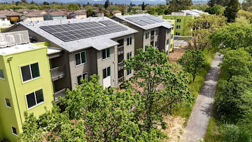 Apartment complex with solar panels on the roof.