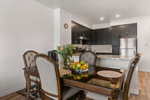 a kitchen and dining room with a table and chairs