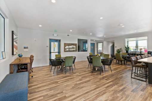 a large living room with tables and chairs