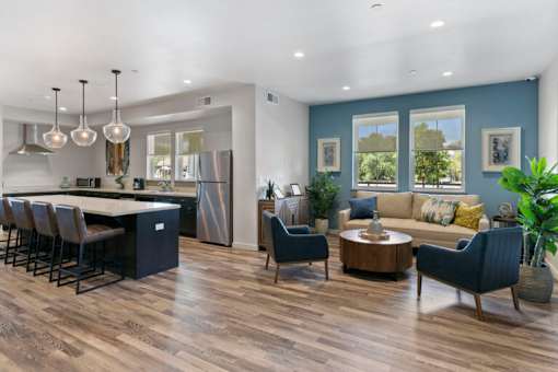 a living room with a kitchen and a table and chairs