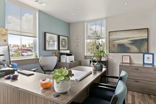 a home office with a wooden desk and a computer