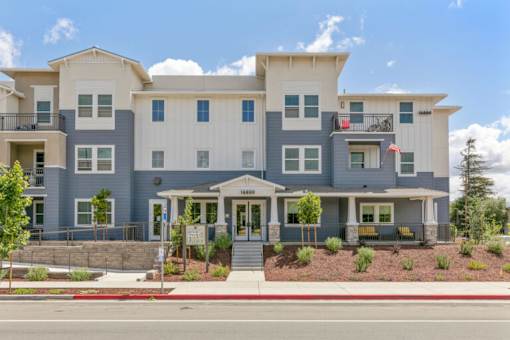 a large apartment building on the side of a street