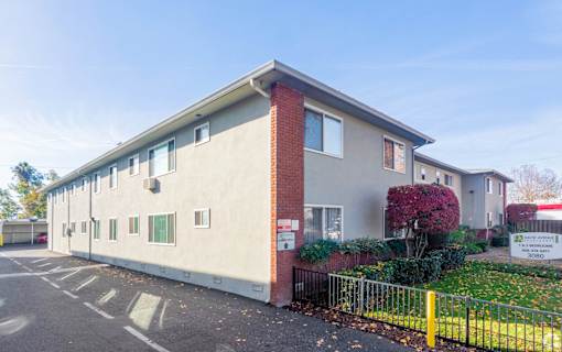 A building with a red brick chimney and a sign that says "22" on it.
