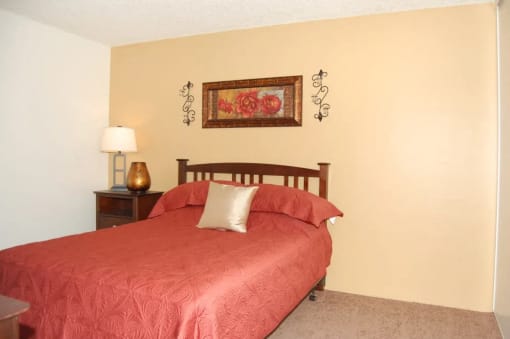 a bedroom with a bed and bedside table