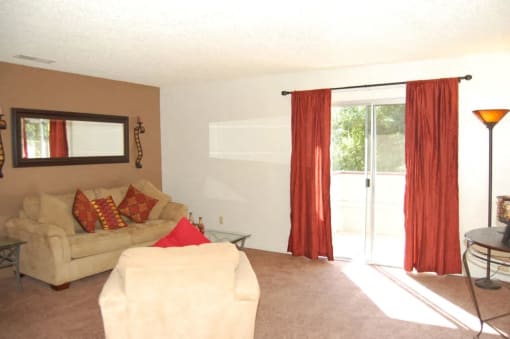 a living room with a couch and a sliding glass door