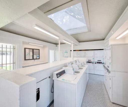 A white laundry room with a washer and dryer.