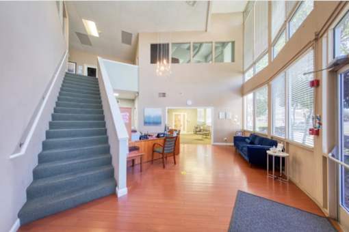 A living room with a staircase leading to the upper floor.
