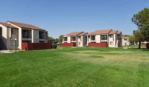 a row of houses on a green lawn