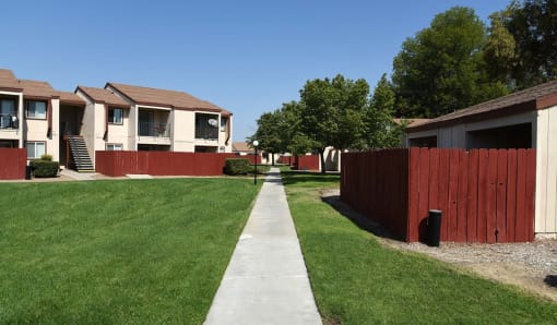 a sidewalk in front of a row of houses
