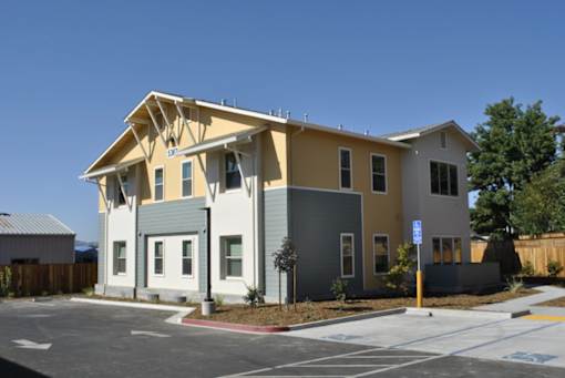 A modern two-story house with a yellow and grey exterior.