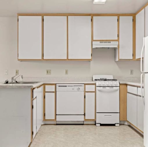 a kitchen with a stove top oven next to a sink