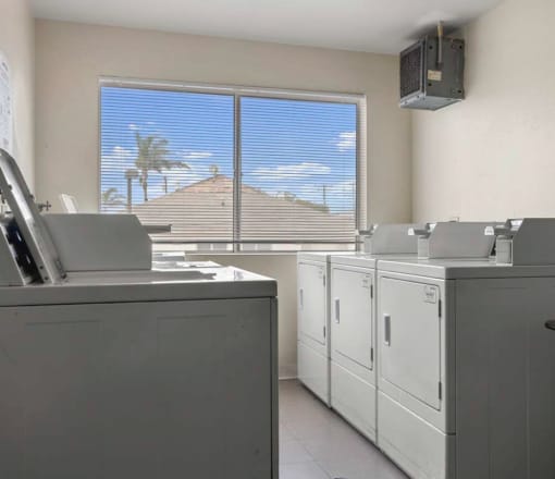 a washer and dryer in a room with a large window