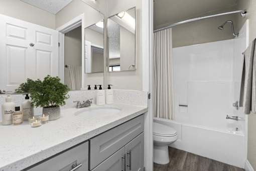 a bathroom with a sink and a shower and a toilet at Harbor Terrace Apartments, California