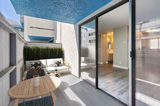 a small balcony with a table and a couch at Harbor Terrace Apartments, San Pedro , California