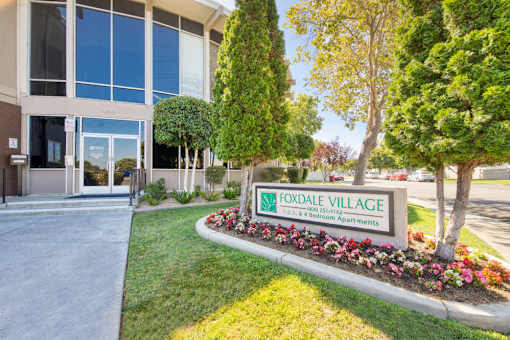 A sign for Foxdale Village Bed and Breakfast is in front of a building.