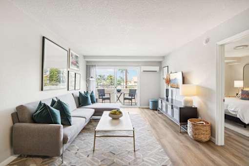 A living room with a grey couch and a white coffee table.