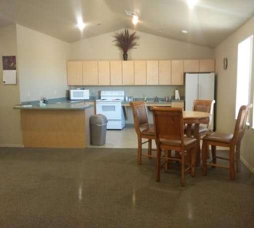 a kitchen and dining area with a table and chairs