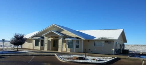 a manufactured home in a parking lot with a blue sky in the background
