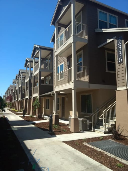 a row of apartment buildings on a sunny day