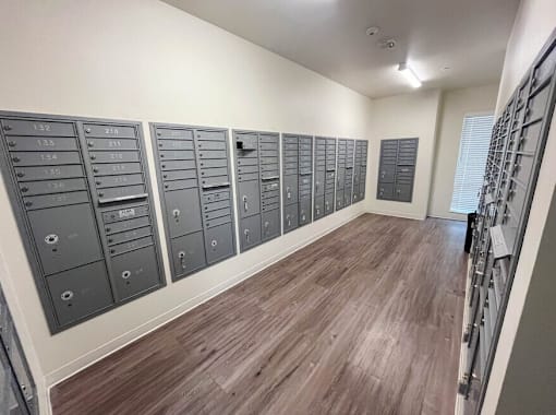A room with a row of mailboxes on the wall.