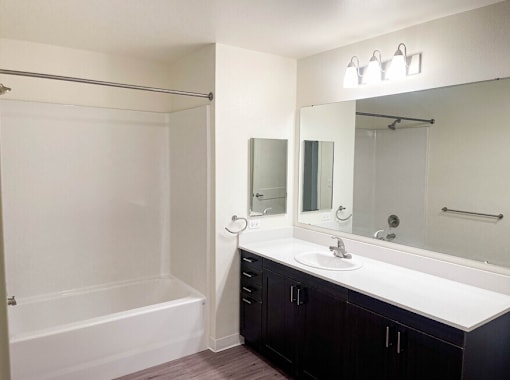 A white sink is on a countertop in a bathroom.