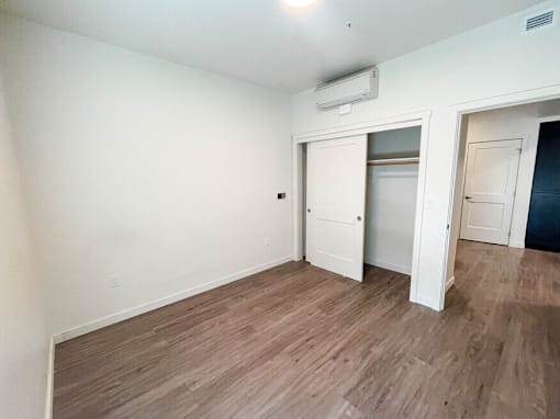 A room with a wooden floor and white walls.
