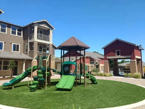 a playground with slides and a gazebo