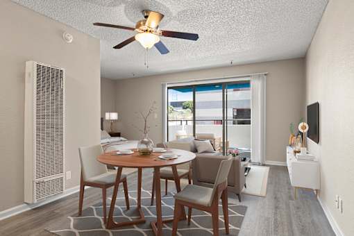 A dining room with a table set for two and a ceiling fan in a studio apartment at Harbor Terrace Apartments, California, 90731