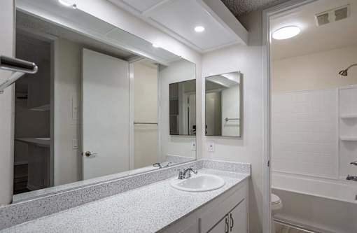 a bathroom with a sink and a mirror at The Arbors Santa Ana, California, 92705