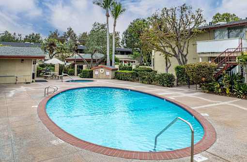 a swimming pool in the middle of a resort style pool at The Arbors Santa Ana, California, 92705