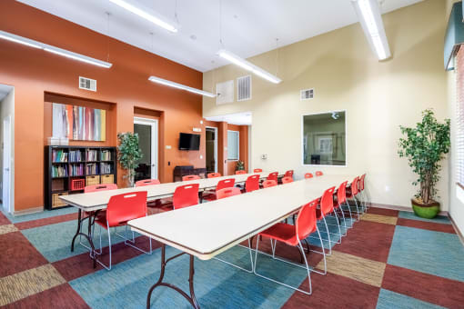 a large conference room with a long table and chairs