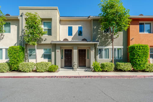 the front of a house with a street in front of it