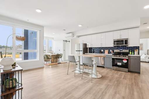A modern kitchen with a dining table and chairs.