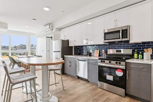 A modern kitchen with a dining table and chairs.