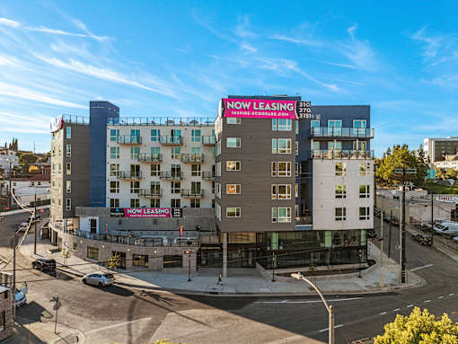 A multi-story building with a "Now Leasing" sign on the side.