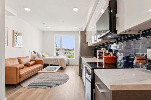 A modern kitchen with a large island and a view of the outdoors.